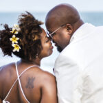 African American couple getting married at the beach